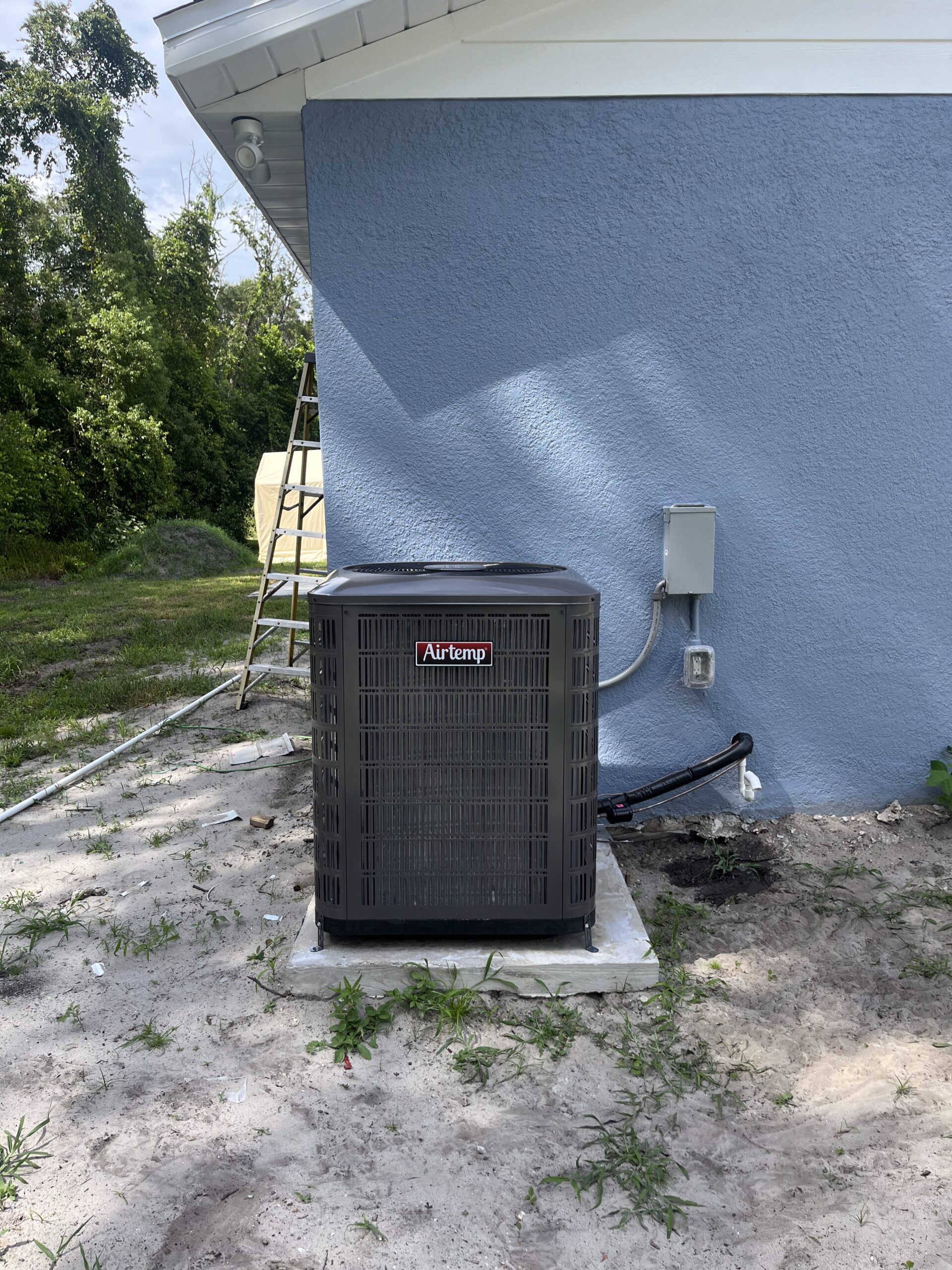 Technician performing home AC maintenance to improve cooling efficiency throughout the year