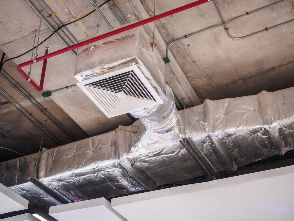 HVAC technician inspecting dirty air ducts affecting HVAC system performance